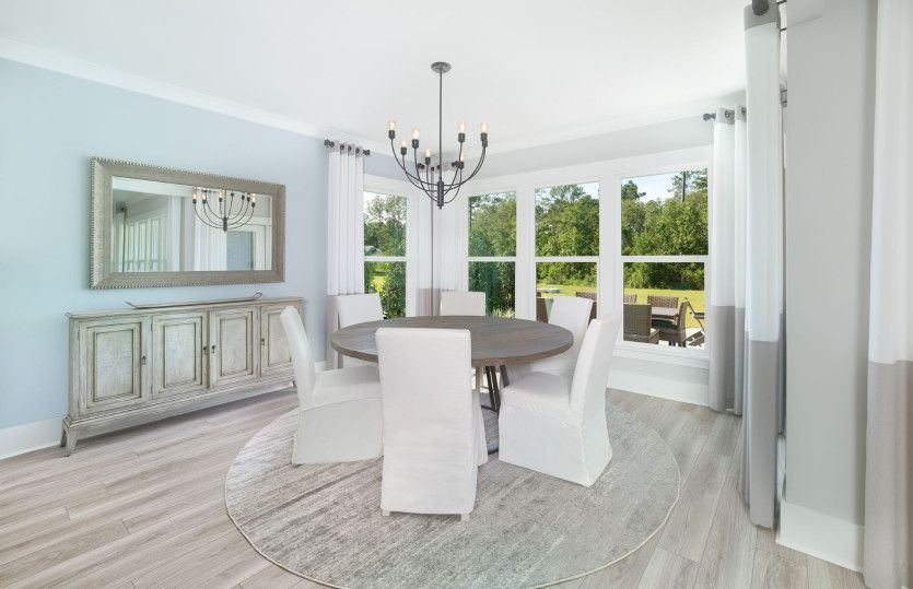 Dining Room with hardwood floors and an optional tray ceiling.