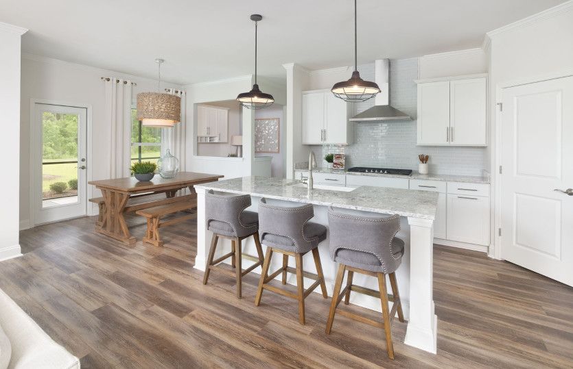 The kitchen flows seamlessly into the café as natural light from the nearby window illuminates the r