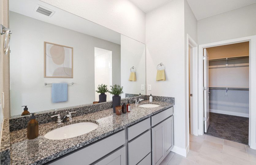 Getting ready each morning is a breeze thanks to the dual sink vanity and large mirror.