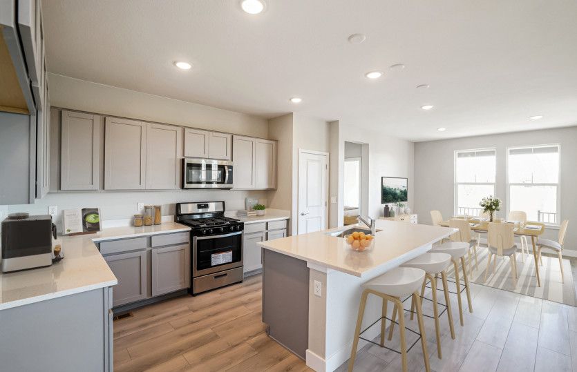 The kitchen features ample cabinet space and a large kitchen island with a built-in breakfast bar.