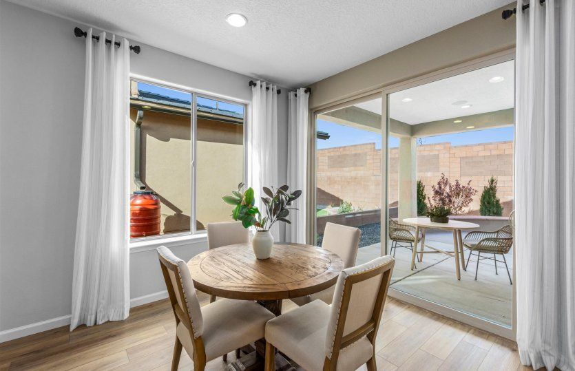 Café off the kitchen has a sliding glass door to the covered patio and backyard.