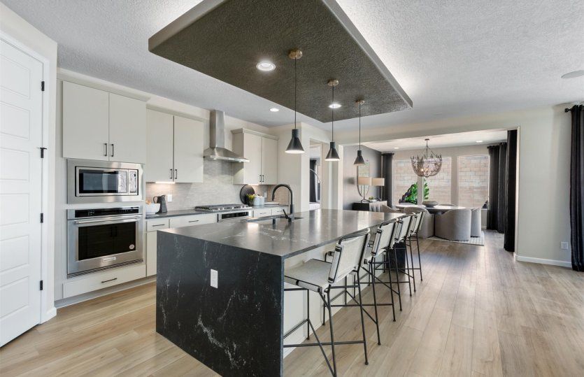 Award-winning Parklane home design is popular for the open gathering room, kitchen, café, and patio