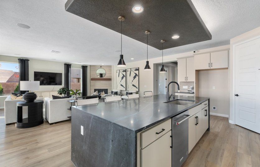 Large kitchen island features a built-in bar overlooking an open floor plan.