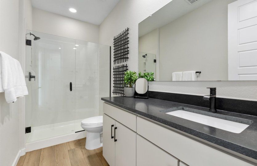 Secondary bath shown here with a large vanity and walk-in shower.