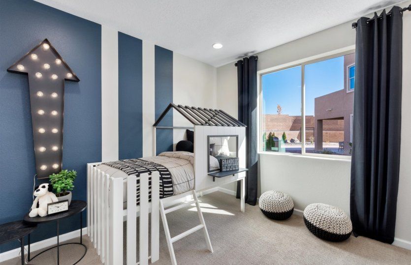 Third bedroom with painted accent wall and large window.