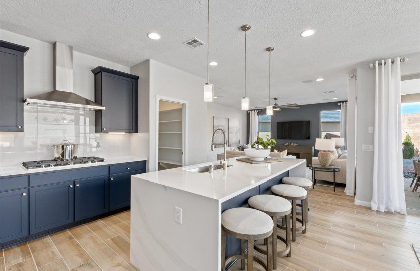 Stylish modern kitchen with stainless-steel appliances and accent lighting.