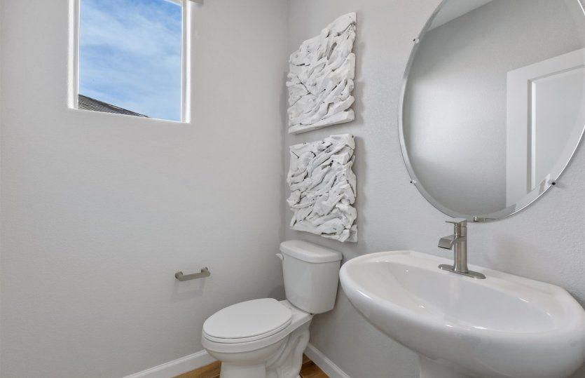 Powder room on the first floor offers convenience for guests.