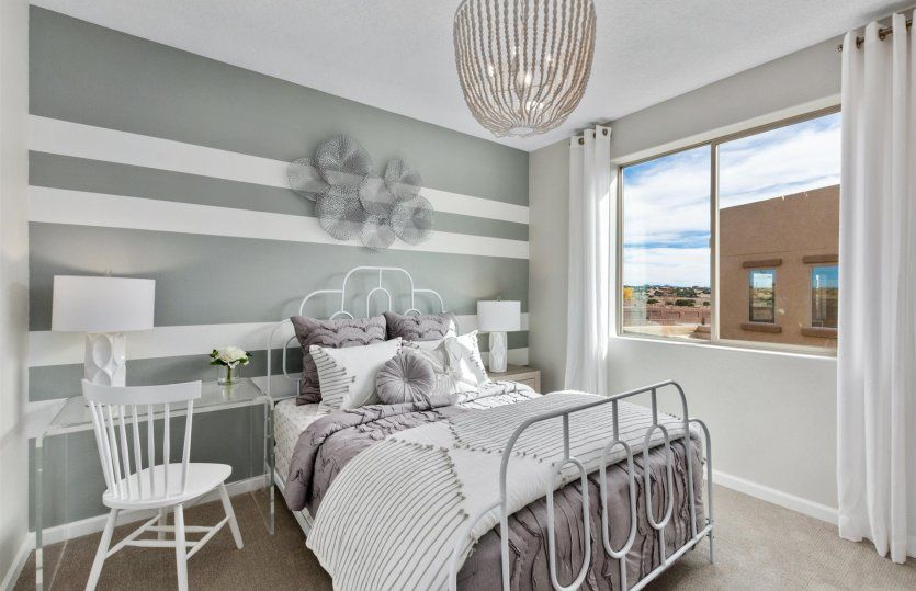 Bedroom 3 on the second floor with a bright window and roomy closet.