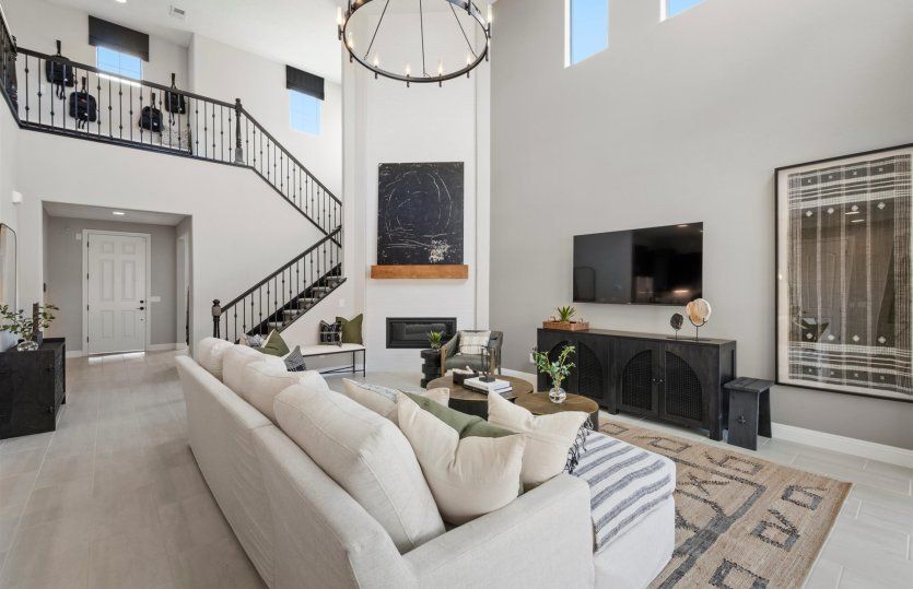 Gathering room and corner fireplace with large, bright windows plus elegant stair railing to the sec