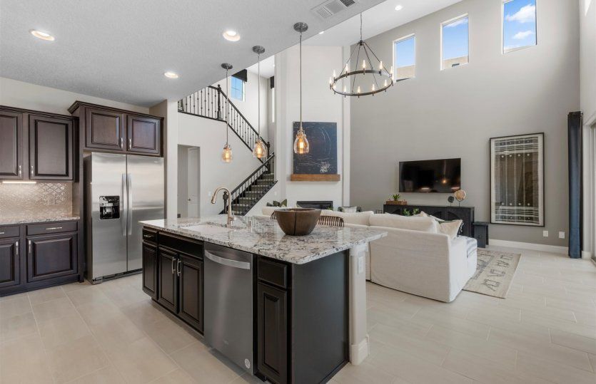 The kitchen island contains a large sink and dishwasher plus additional cabinets.