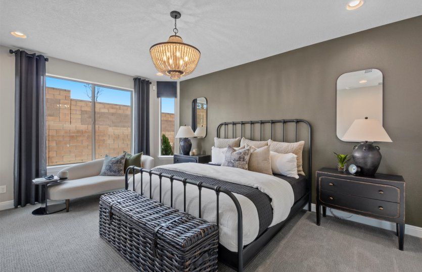 The owner's suite is finished with an accent wall and decorative light fixture.