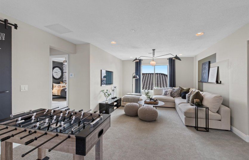 Off the stairs on the second floor is a spacious loft living area serving as a flexible play room be