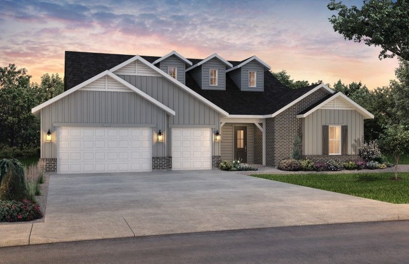 The classic Farmhouse elevation boasts stylish brick accents and window shutters for added curb appe