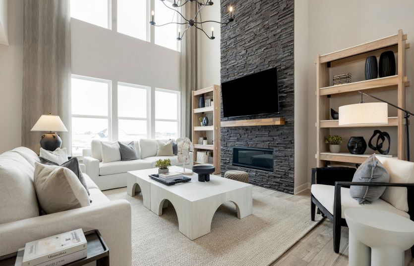 Gorgeous Vaulted Gathering Room with Floor To Ceiling Stone Accent on Fireplace