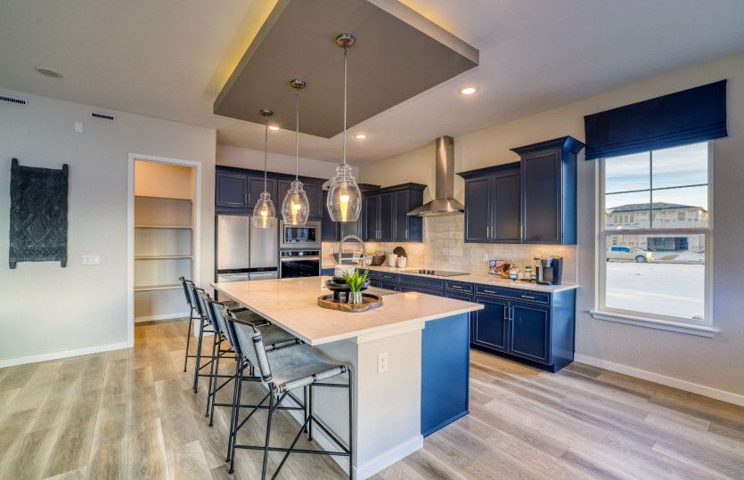 Enhance your kitchen with designer upgrades like an accented tray ceiling, pendant lighting, and qua
