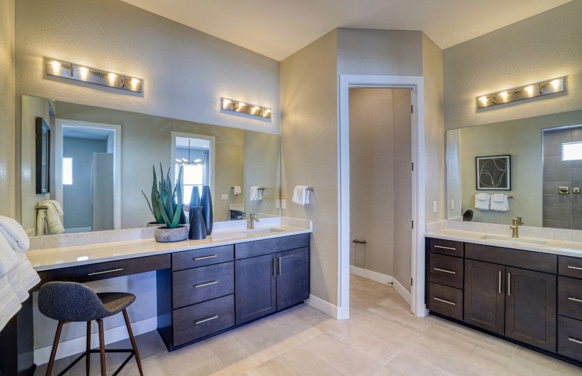 The Cesena owner's bath features split sinks and a vanity space to make getting ready each morning a