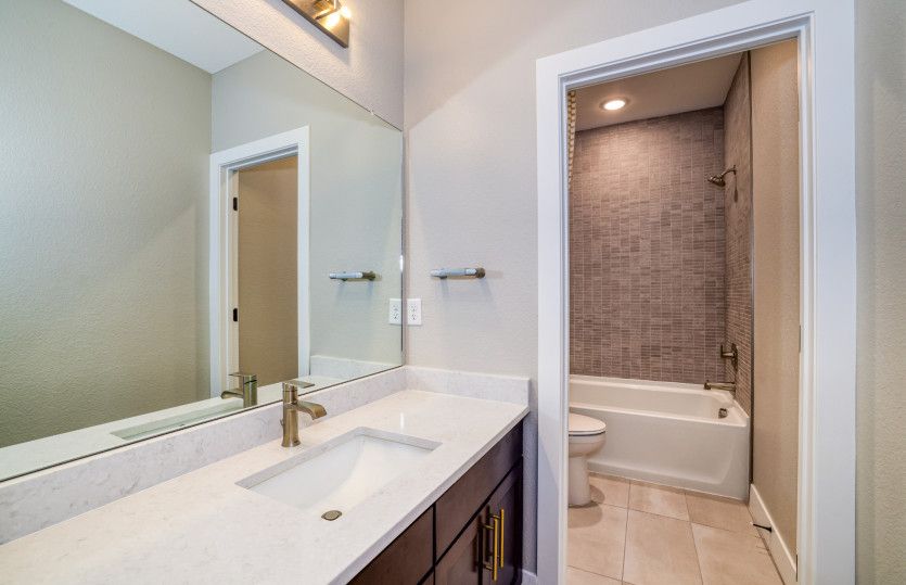The basement bathroom features a full shower/tub combo.