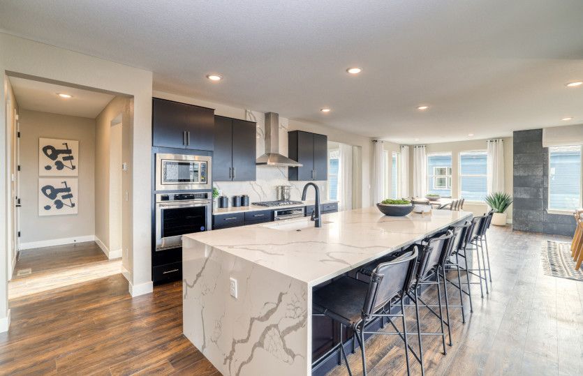 The stunning quartz countertops add an elegant flair to the functional kitchen.