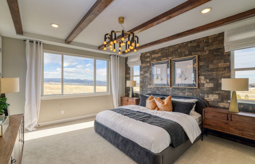 The spacious owner's suite can be enhanced with stylish upgrades like the brick accent wall shown he