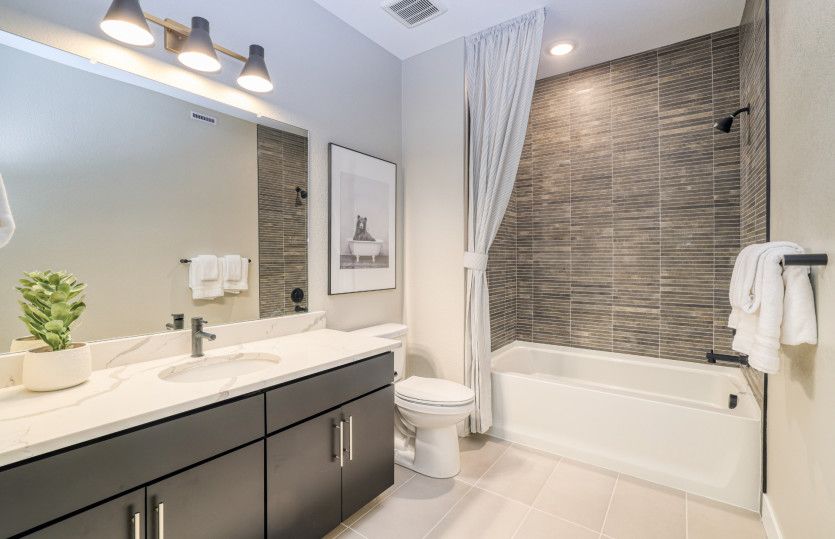 The secondary bathroom features a full shower/tub combo.
