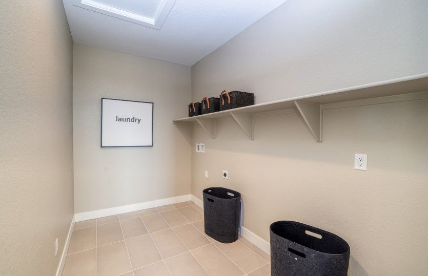 The laundry room is conveniently located upstairs near the main bedrooms.