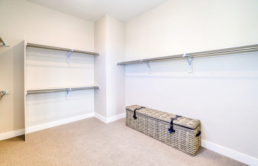 The owner's suite boasts a large, walk-in closet with built-in storage for added functionality.