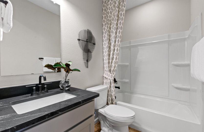 The guest suite features a full shower/tub combo and stylish granite countertops.