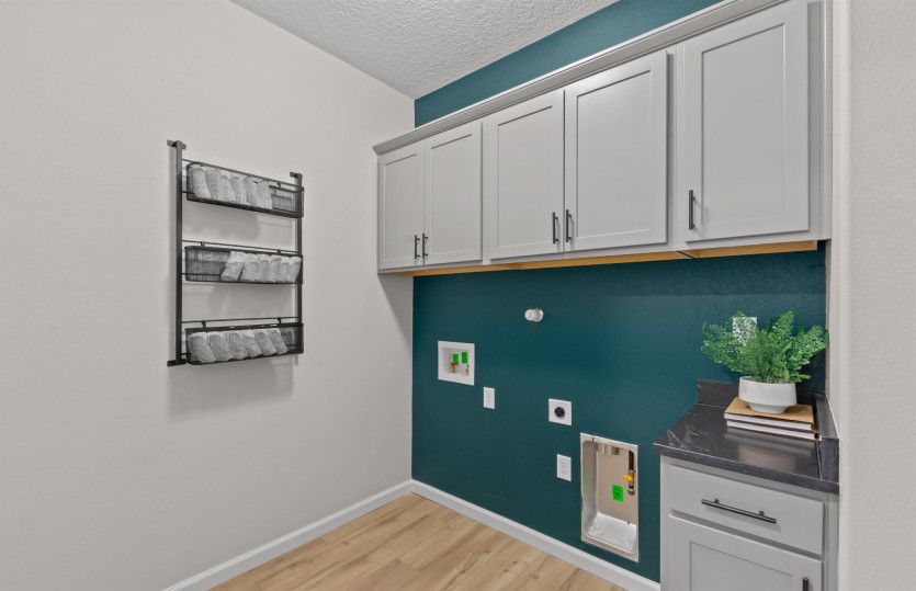 The laundry room features built-in cabinets for additional storage and functionality.