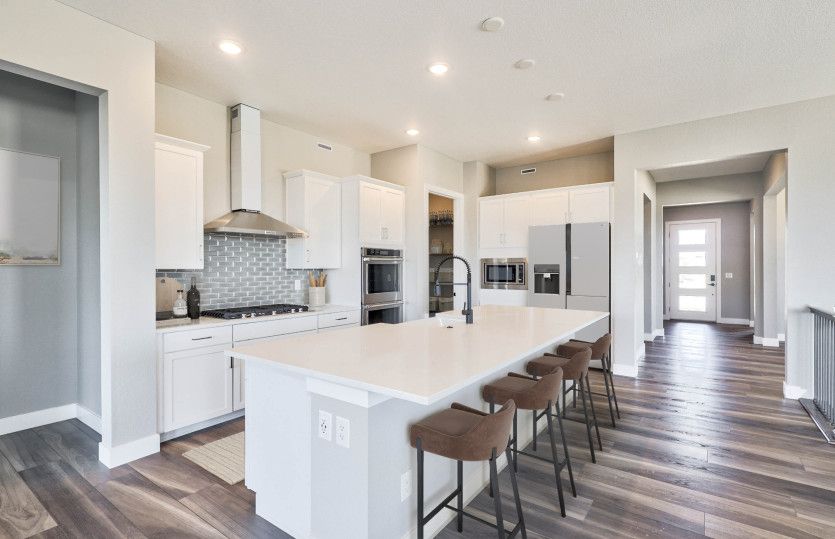 Enter the Preserve kitchen to find a large island, ample cabinet space, and built-in appliances.