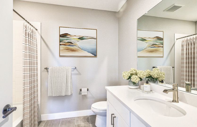 The basement bathroom features a shower/tub combo and granite countertops.