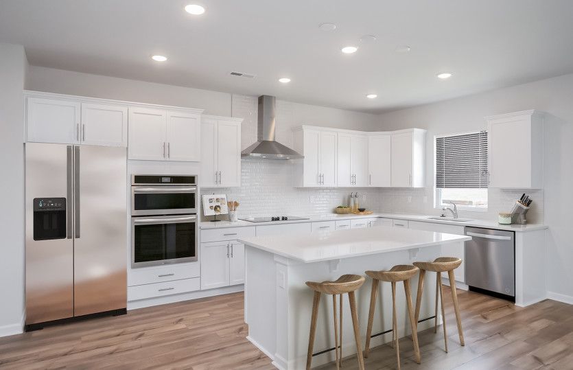 Bright white Kitchen with an island.
