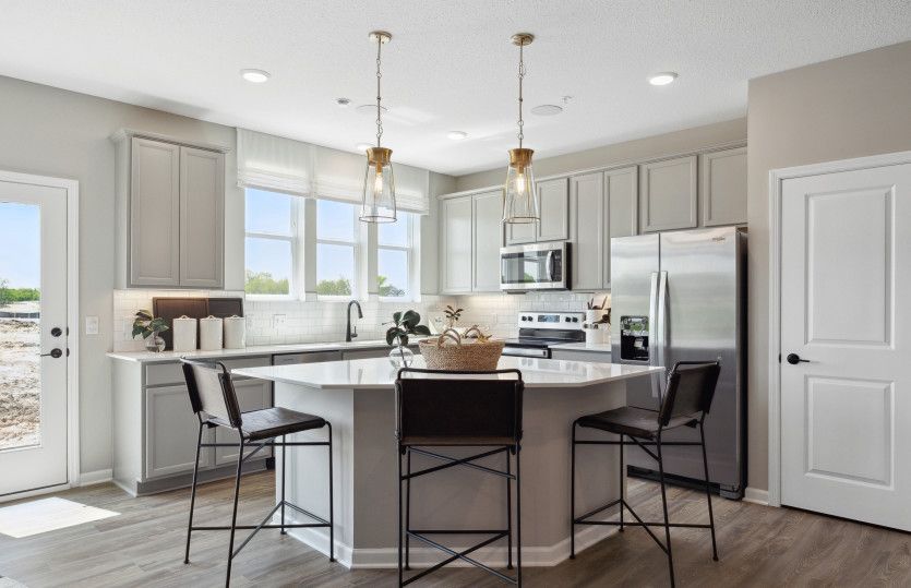 The bright, spacious, and inviting kitchen floods with natural light.