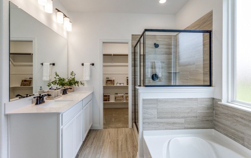 Luxury owner's bath with shower, tub, and double vanity