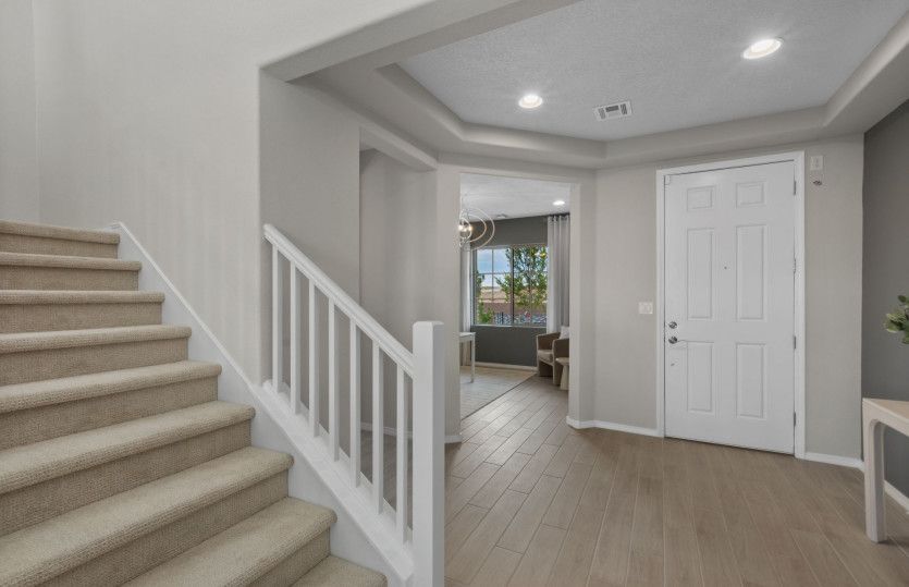 The first floor of the Trento includes a spacious entry with a tray ceiling plus a stair set to the