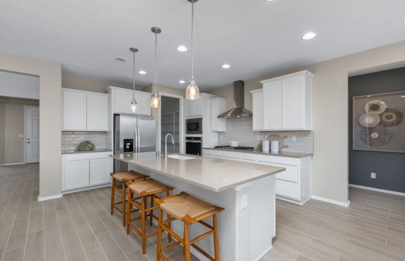 Your expansive kitchen island overlooks the gathering room as well as the cafe for seamless entertai