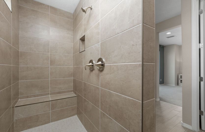 Unwind in the spacious, walk-in shower featuring tile accents.