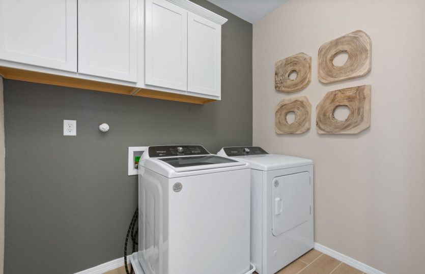 The upstairs laundry room boasts additional storage space.