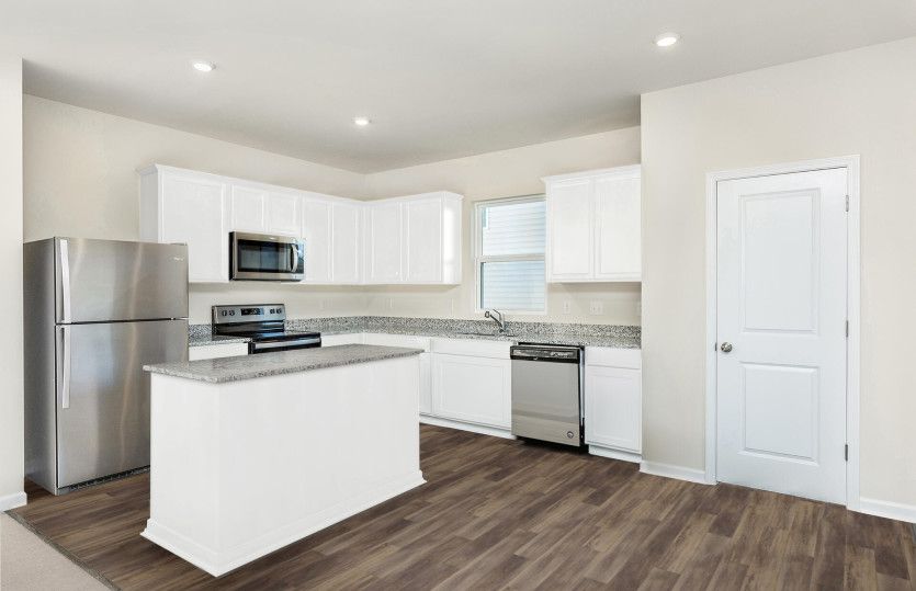 Package A Kitchen with beautiful white cabinets and granite countertops.