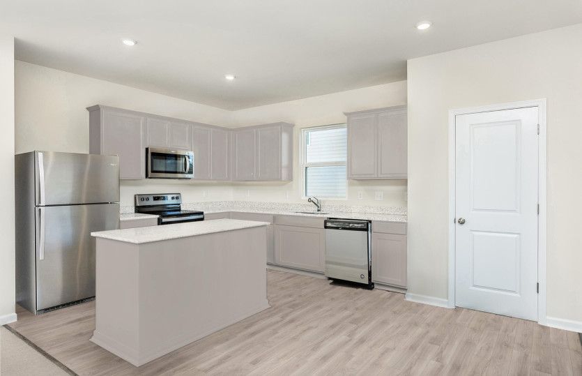 Package B Kitchen with beautiful gray cabinets and granite countertops.