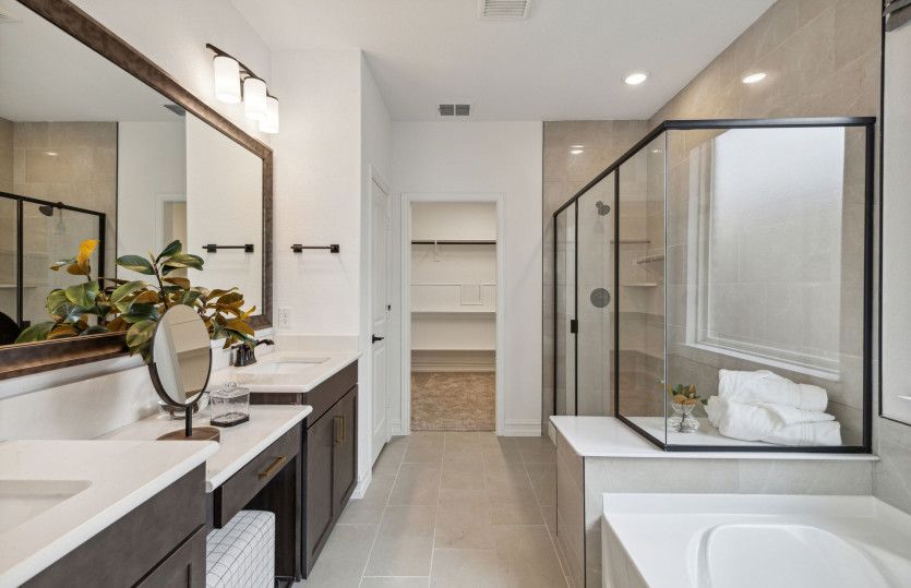 Spacious owner's bath with double vanity and large shower