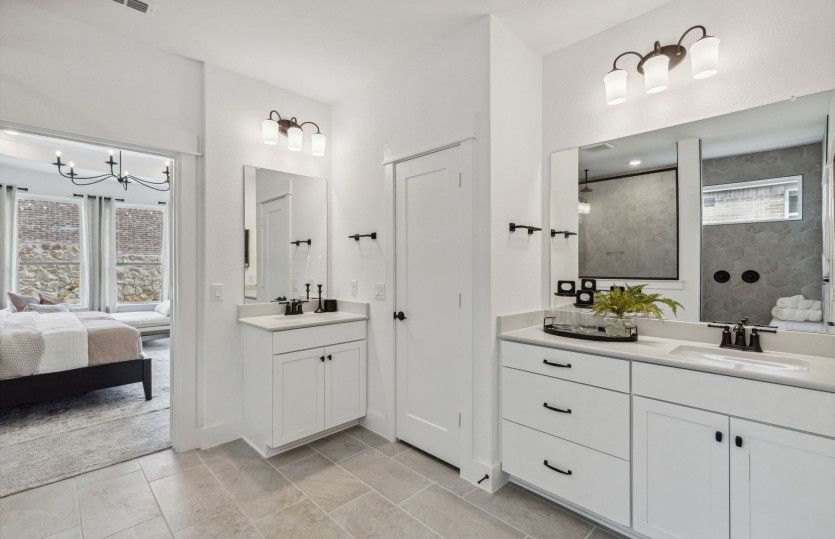 Separate vanities in owner's bath