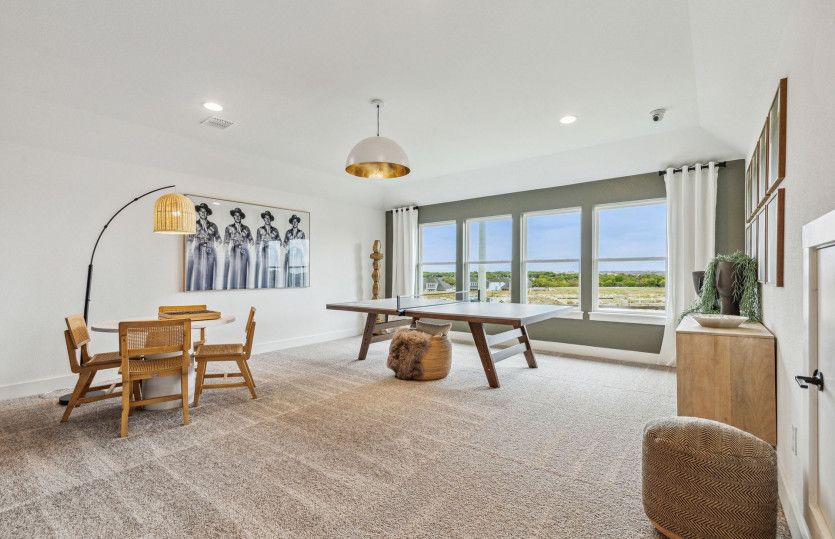 Spacious upstairs game room with large windows*model representation