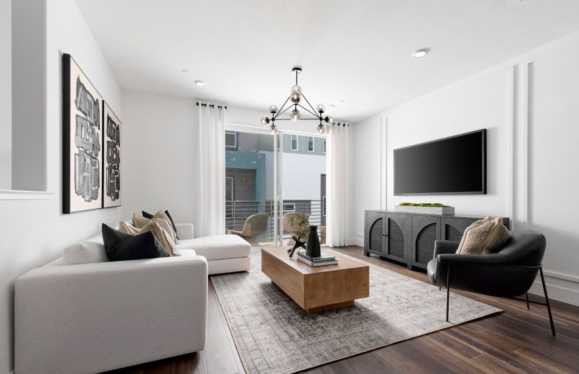 Gathering room with sliding glass door and balcony access