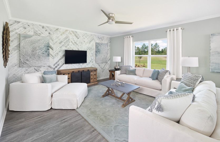 A cozy Gathering Room with accent wall offers space for everyone to be comfortable.