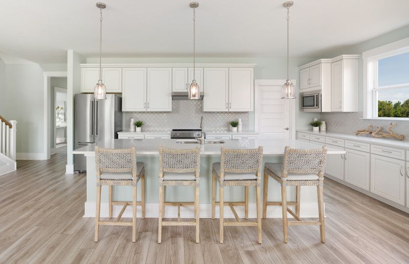 Bright open Kitchen with stunning light pendants.