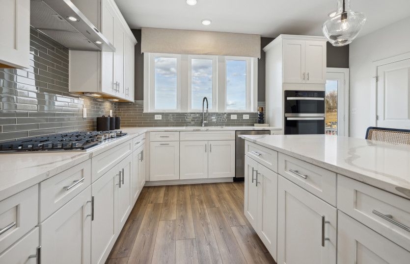 Stainless Steel Appliances and Quartz Countertops in the Spacious Kitchen