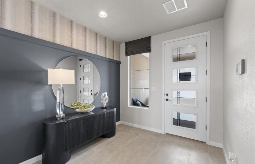 Walk in to an impressive foyer with a custom accent wall and modern front door.