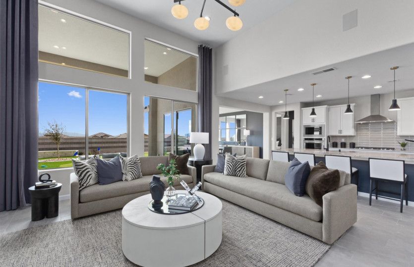 Open living space showing kitchen, dining and gathering room.