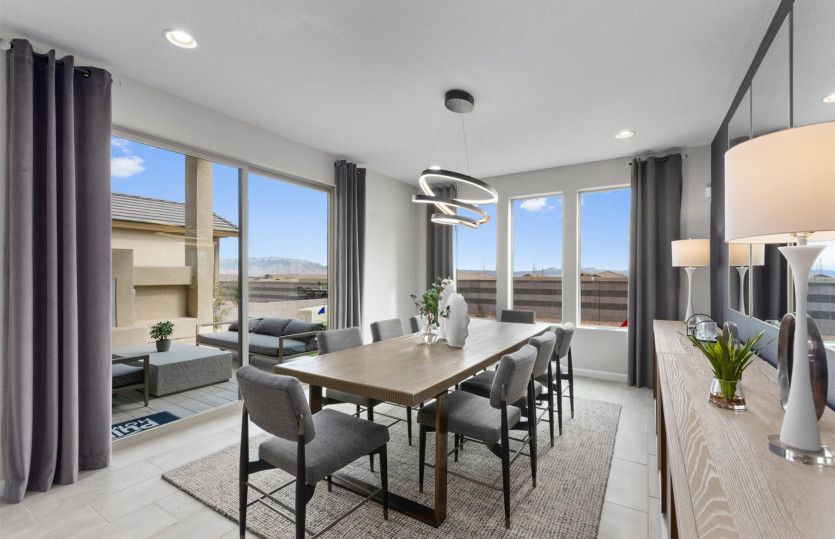 Dining room has a large sliding glass door for outdoor patio access, and extra windows giving lots o