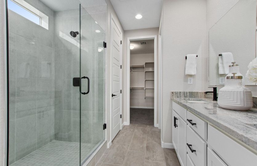 Enjoy a walk-in shower with tile surround and a thick sliding glass surround door.
